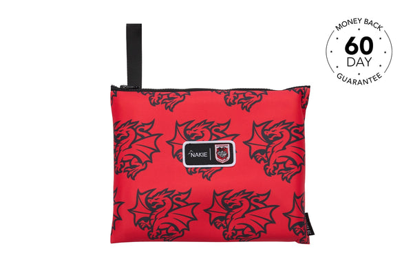 Red dragon-print recycled sand-free beach towel with black carrying strap and Nakie logo patch