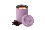 Dusty pink insulated coffee tumbler with black lid, filled with latte art, shown with matching lid and coffee beans. preview #4