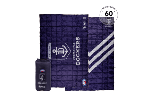 Navy quilted puffy blanket with Fremantle Dockers AFL branding, displayed open with matching compression bag