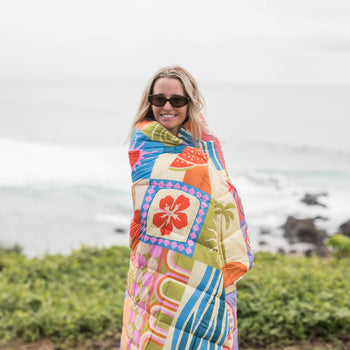Retro Shores sustainable down puffy blanket with colorful geometric patchwork pattern in orange, blue