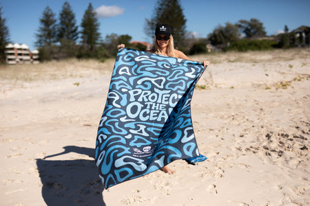Blue and white abstract patterned recycled beach towel with 