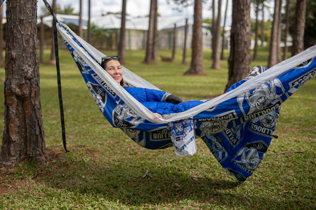 Woman in NRL Bulldogs hammock with a Bulldogs puffy blanket