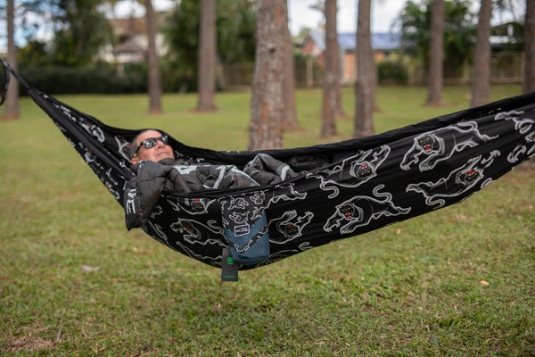 Black Panthers NRL recycled hammock with white dog print, straps included, displayed in outdoor setting