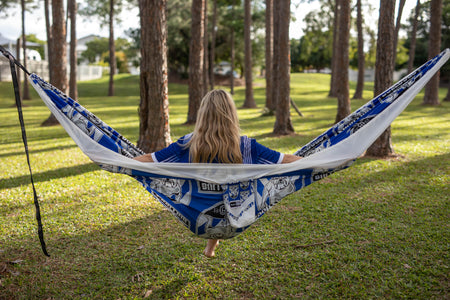 Back view of woman sitting in Nakie NRL Bulldogs hammock.