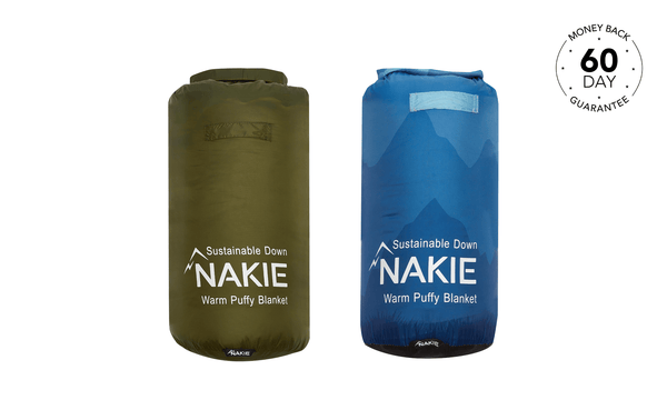 Two puffy blankets in olive and navy, labeled Nakie Warm Puffy Blanket with mountain logo and light blue carry handles.