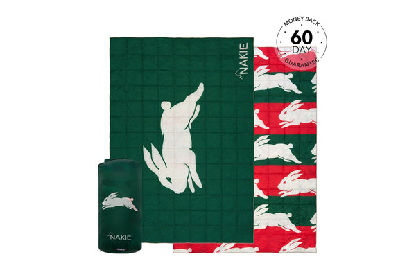 Green and red quilted blanket with white rabbit pattern, shown rolled and unrolled with carry pouch.