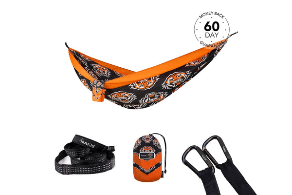Orange and black tiger-patterned recycled hammock with straps and carabiners, displayed with carry bag